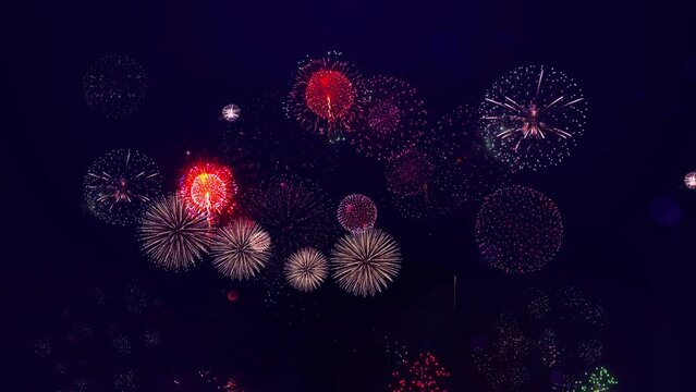 Colourful shining fireworks with bokeh lights fireworks are glowing in night sky. Celebrations and events. Firework during new year eve countdown festival. 4th of July. Confetti Party Popper Explosion