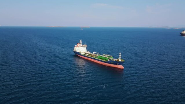 Cargo Oil chemical tanker ship in anchorage near industrial port at sea, aerial shot