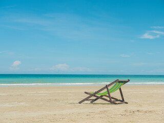 Fototapeta na wymiar Sun bed chair on empty tropical ocean beach at hat Namsai East of Thailand.