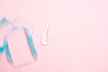 Cosmetic samples texture. Smears of transparent liquid cosmetics on a pink background