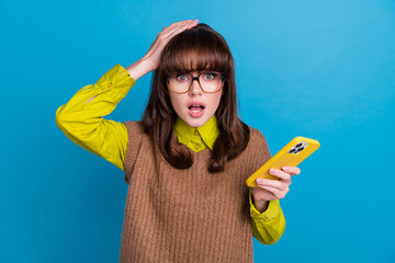 Photo of funny shocked lady wear brown vest spectacles arm hand head reading news modern gadget...
