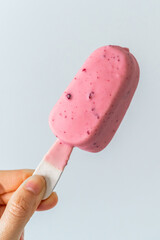 Holding a pink ice cream