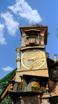 The Old Clock Tower of Tbilisi: A Symbol of the City's History and Culture in the heart of the City old Tbilisi in Georgia. yellow x gold with angle ringing the bell 