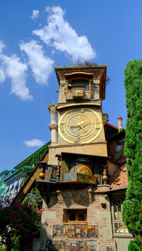 The Old Clock Tower of Tbilisi: A Symbol of the City's History and Culture in the heart of the City old Tbilisi in Georgia. yellow x gold with angle ringing the bell 