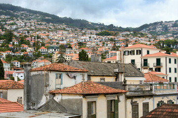 The orange terracotta tiled roofs on the villas, new and old, all across Madeira town. Funchal, Portugal