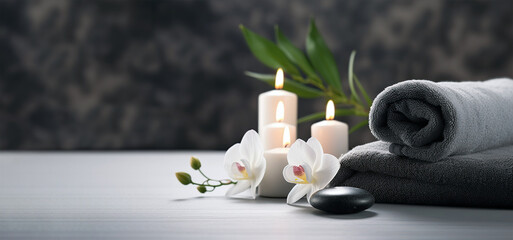 spa treatment background. towels with candles and flowers. banner with copy space