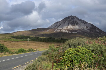 Errigal Mountain viewed from roadside against backdrop of overcast skies, County Donegal, Ireland