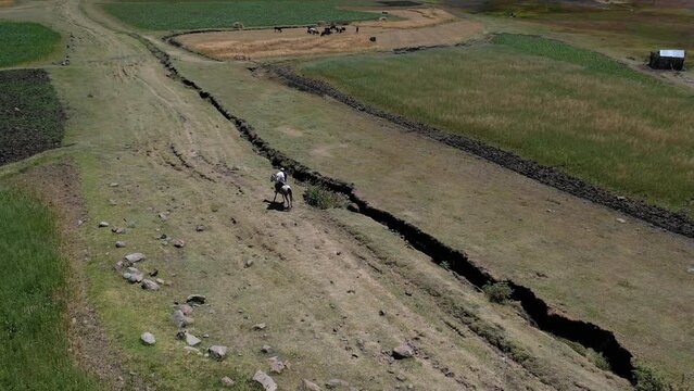 Aerial view of man riding a horse in the highlands AmharaWeldiya Ethiopia