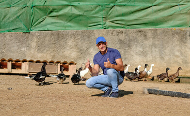 man on a small chicken and duck farm