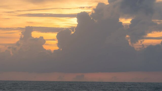 Timelapse. Big bright Yellow sun down behide big cloud . Awesome landscape of sky and silhouette.