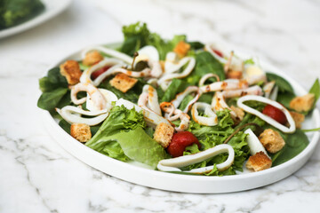 Leaf salad with grilled squid and croutons