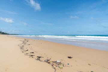 Fototapeta na wymiar Beach pollution. Lots of Trash, plastic bottles and litter on the coastline