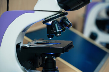 Microscope close-up in the laboratory using metal lenses.