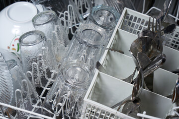 Inside of a dishwasher filled with dirty dishes.