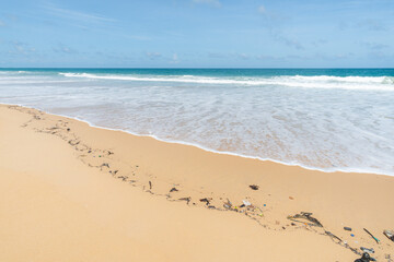 Fototapeta na wymiar Beach pollution. Lots of Trash, plastic bottles and litter on the coastline