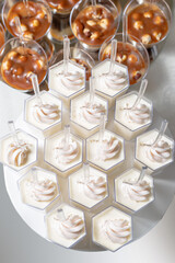 Candy bar. Festive table with desserts, and cakes, fruit tartlet, cupcakes and macarons. Wedding. Reception Tartlets