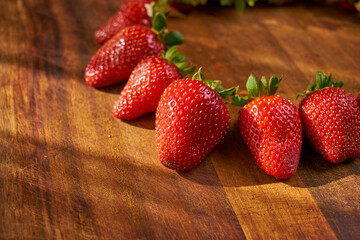Fresh and juicy organic strawberries on chefs table.