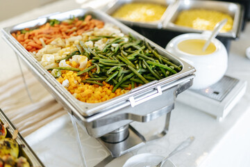 Steamed vegetables in a silver tray at a wedding buffet