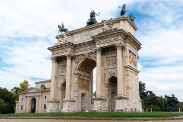 Fototapeta na wymiar Arco della pace in Milan. The triumphal arch is covered by a green grass spot.