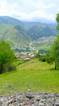 A View to Infinity: The Kazbegi Mountains Rise Above the Clouds, surrounding the small town of Kazbegi Mkinvartsveri in Georgia in a cloudy day in summer, Gudauri gergeti trinty church, ananuri