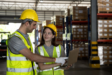 Warehouse man and woman workers with notebook working in manufacturing contribution  factory warehouse 