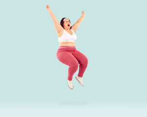 Full length photo of a funny overjoyed young fat woman wearing sportswear jumping with excited...