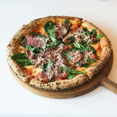 Pizza with prosciutto and basil