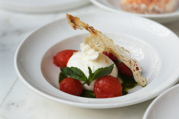 Fresh burrata cheese with tomatoes and basil