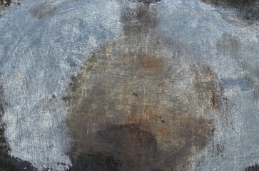 Rusty and worn metal layer with spilled paint