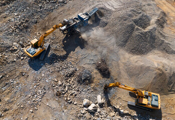 Concrete Recycling and asphalt from demolition. Excavator at landfill the load concrete waste in a...