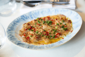 White fish appetizer with pepper and spring onion