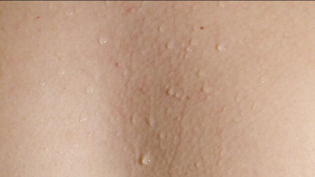 sweat flows down on the human body closeup