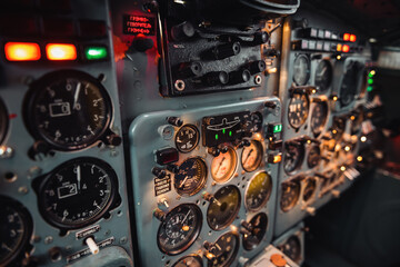Control panel of 1970-s soviet aircraft. Selective focus shot of gauges and switches on center console inside pilot's cabin