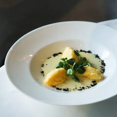 Traditional polenta served with spinach sauce