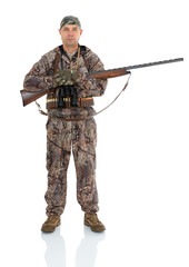 Full length portrait of duck hunter with a rifle on his shoulder and binoculars with folding arms isolated on white background. Fifty-year-old man in hunting uniform with a shotgun posing in studio