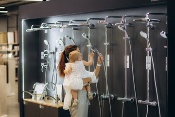 mother and daughter choose a shower in the store