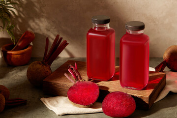 A wooden podium in rectangle-shaped featured two unbranded bottles of beetroot juice, displayed...