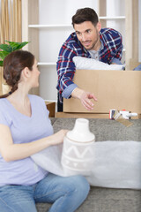 young couple moving to new flat with fragile things