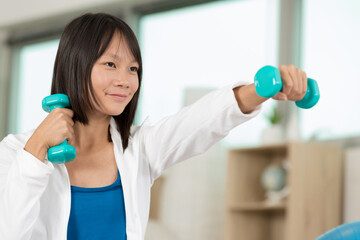 happy young woman with dumbbells working out
