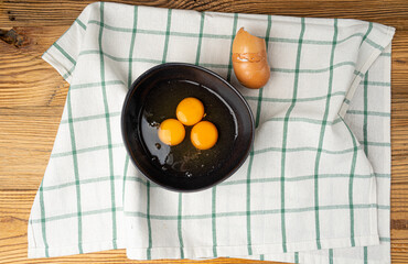 Two Broken Eggs in Bowl Isolated, Raw Yolk and White, Fresh Broken Organic Chicken Eggs