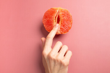 Fototapeta  A woman is holding a grapefruit by her panties. Concept masturbation obraz