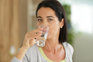 woman drinks water at home