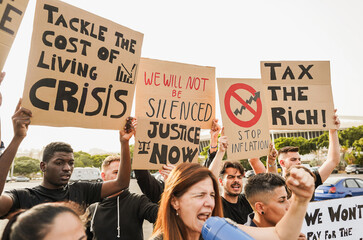 Crowd of multiracial people protest against inflation and financial crisis - Protesters marching for rise cost of living - Focus on banners - obrazy, fototapety, plakaty