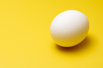 A free-range egg on a yellow background