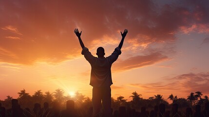 Human silhouette raising hands in prayer to God on blurred sunset background with cross and crown of thorns - obrazy, fototapety, plakaty
