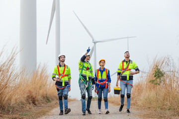 Teamwork engineer worker wearing safety uniform discuss operational planning at wind turbine field...