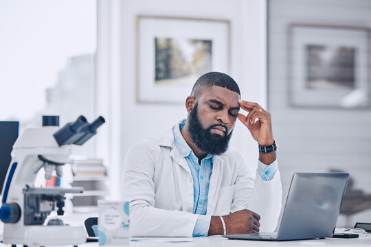 Headache, stress and man with burnout from science, research mistake or laptop error in laboratory. Tired, sad or frustrated african scientist with migraine pain, anxiety and fatigue of mental health