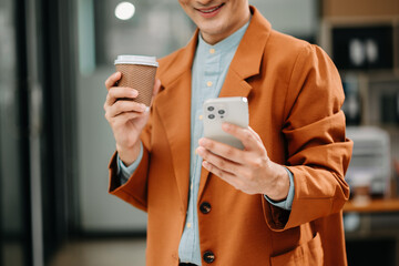 Businessman s hands typing on smartphone, tablet and laptop keyboard computer, typing, online in office.