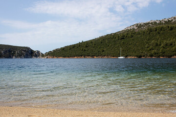 Obraz premium Panorama of a beautiful sea bay with green forest and whtie boat. Beautiful summer concept.
