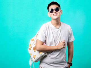 A portrait of an Asian man wearing a white shirt and black glasses, carrying a drawstring bag over...